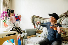 Grandpa And Granddaughter Playing At Home