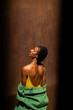 © Alba Vitta/Stocksy - Sensual male african model on rusty wall