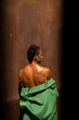 © Alba Vitta/Stocksy - African model from behind taking off coat