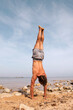 © Lucas Ottone/Stocksy - Man working out at the beach