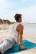 © Lucas Ottone/Stocksy - Man exercising at the beach