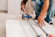 © Ángela Rober/Stocksy - Man cutting porcelain tile