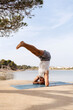© Lucas Ottone/Stocksy - Man practicing yoga outdoors