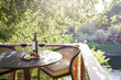 © Trinette Reed/Stocksy - Cheese plate with wine on table on outdoor backyard deck