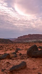 timelapse of black rocks in the red desert landscape in capitol reef in the utah wilderness.