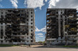 © Andriy Bezuglov/Stocksy - Facade of a bombed-out apartment building.