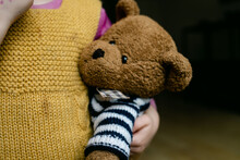 Teddy Bear Being Held Under Arm