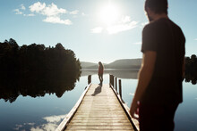Standing Man And Woman On Mirror Lake Dock