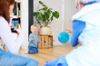 © Guille Faingold/Stocksy - Smiling baby on his knees in front of relatives.