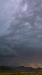 Wall Mural - Lightning flashing as storm clouds move over the landscape in Utah during sunset.