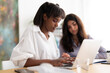 © Studio Marmellata/Stocksy - Young diverse women working on laptop in office