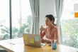 © Marc Tran/Stocksy - Asian business woman working in the office with laptop