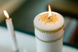 © Leah Flores/Stocksy - Closeup of Lit, Decorated Candle