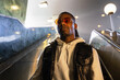 © Luciano Spinelli/Stocksy - Stylish man is going down the escalator during commuting home