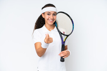 Young tennis player woman isolated on white background making money gesture