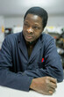 © Lupe Rodríguez/Stocksy - portrait of black man cobbler in his business