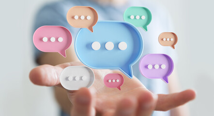 Wall Mural - Businessman using digital speech bubbles talk icons. Minimal conversation or social media messages floating over user hand. 3D rendering