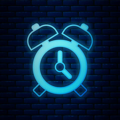 Poster - Glowing neon Alarm clock icon isolated on brick wall background. Wake up, get up concept. Time sign. Vector