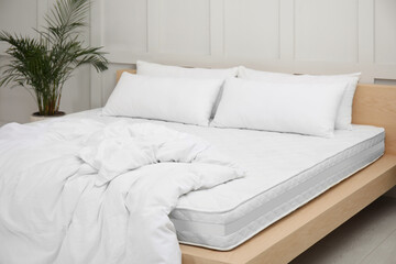 Sticker - Wooden bed with soft white mattress, blanket and pillows indoors