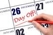 © Alena - 26th day of December. Hand writing text DAY OFF and drawing a line on calendar date 26 December. Vacation planning concept. Winter month, day of the year concept.