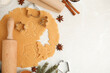 Flat lay composition with dough and cookie cutters on white table, space for text. Christmas biscuits