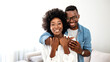 © Dragana Gordic - Portrait of happy african american couple hugging at home. Portrait of man with his woman looking at camera. Black mid adult couple. Meeting, love and date of young people