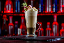 Cocktail Layered Baileys Irish Cream Iced Coffee On Bar Counter In A Restaurant, Pub. Drink With Liqueur. Fresh Prepared Alcoholic Cooler Beverage At Nightclub. Showcases With Bottles, Dark Background