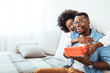 © Dragana Gordic - Valentine's day. Couple gives gift box to the Valentine's Day in the room. Beautiful young couple at home. Hugging, kissing and enjoying spending time together while celebrating Saint Valentine's