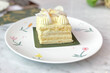 Close up of coconut cream cake on the white plate with blur background.