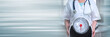 © thodonal - Female doctor holding a weight scale; panoramic banner