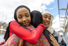 Young Women Wearing�hijabs�hugging In City
