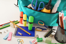 School Supplies And Blue Backpack On White Table