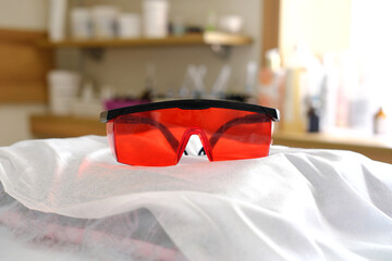 protective red glasses UV protection in cosmetology dentistry laser depilation teeth whitening.