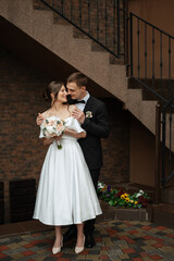 Wall Mural - young couple bride and groom in a white short dress