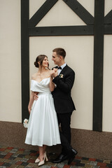 Wall Mural - young couple bride and groom in a white short dress