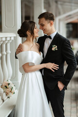 Wall Mural - young couple bride and groom in a white short dress