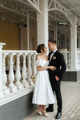 Wall Mural - young couple bride and groom in a white short dress