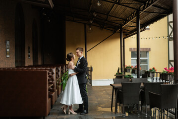 Wall Mural - young couple bride and groom in a white short dress