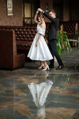 Wall Mural - young couple bride and groom in a white short dress