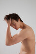 © Allen Penton - Cute young man with his shirt off and looking serious