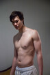 © Allen Penton - Cute young man with his shirt off and looking serious