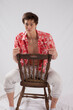 © Allen Penton - Cute young man sitting  with his shirt open