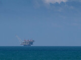 Fototapeta  - Gas production platform in the sea against the blue sky..copy space