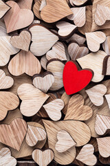 Wall Mural - Wooden hearts, one red heart on the heart background.