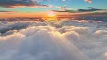 Gorgeous sunset above the clouds in the sky. Sunrays breaking through the clouds. amera rises above the clouds to see the bright sunset sky and the sun