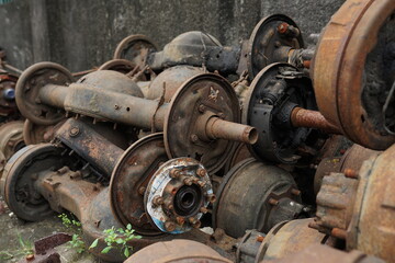 a collection of broken metal truck chassis for sale at a junk metal shop