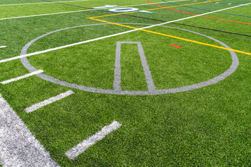 Synthetic turf multi sport field with soccer, football, lacrosse and softball pitching circle lines in white, gray, yellow and red. 