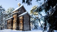 Old Wooden Orthodox Church In A Snowy Field With Trees