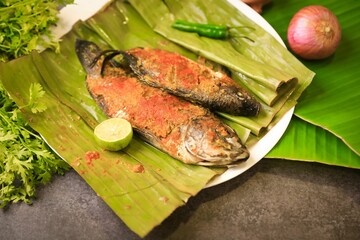 Sticker - Fish cooked in a banana leaf, Kerala style of cooking fish with selective focus and blur