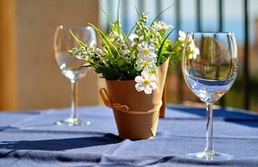 Sticker - Two empty clean crystal wine glasses and a flowers on the table